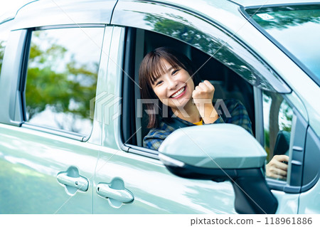 A woman driving a car A woman going for a drive A woman driving a car A woman going for a drive 118961886