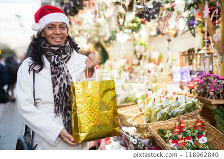 Portrait of a positive Latin American woman who came to a Christmas fair Portrait of a positive Latin American woman who came to a Christmas fair 118962840