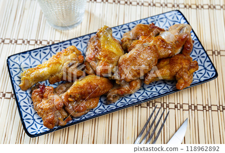 There is hearty snack on plate - large portion of fried chicken wings 118962892