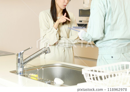 一名婦女向廚房裡的一名男工抱怨 一名婦女向廚房裡的一名男工抱怨 118962978