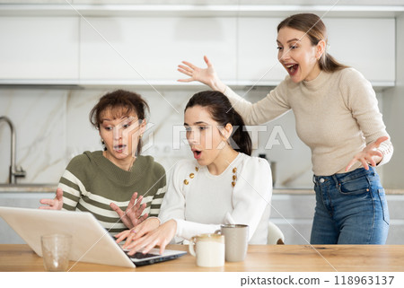 Women are sitting at computer and are immensely happy 118963137