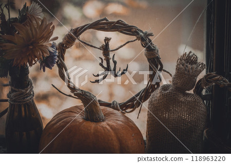 Pagan home autumn altar. Dry birds claws, pumpkin, willow wreath, flowers and canvas bag as a set. 118963220
