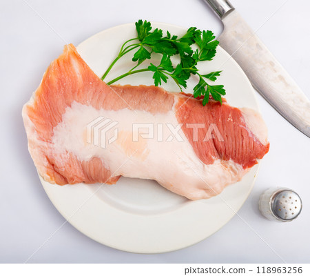 Slice of raw pork chops (Secreto de cerdo) on plate 118963256