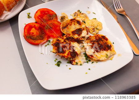 Delicious stuffed scallops with tomatoes closeup 118963385