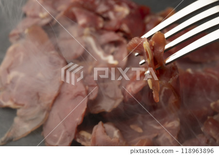Raw ham, beef ham, smoked, smoke, lifting the ham with a fork 118963896