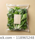 Sticker mockup for fresh green vegetables packaging. Blank light brown vertical rectangle paper on clear plastic bag for brand logo design on beige background. AI generated 118965248