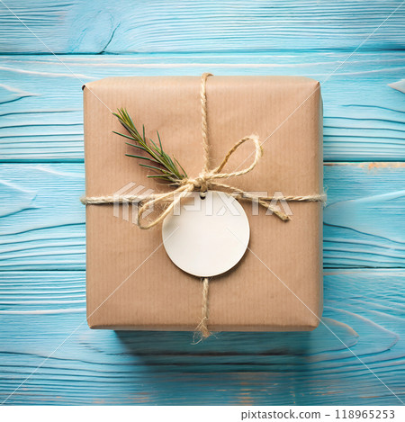 Gift tag mockup. Top view round blank white circle sticker for brand logo label design with brown kraft paper box on blue wooden table background. AI generated Gift tag mockup. Top view round blank white circle sticker for brand logo label design with brown kraft paper box on blue wooden table background. AI generated 118965253