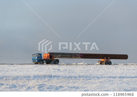 Large tube on dumper in Arctic tundra. Winter time. Construction Marine offshore works. 118965968