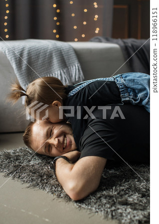Father and daughter playing on cozy living room floor 118966151