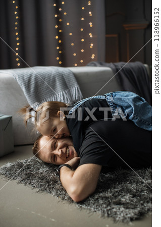 Happy father and daughter playing on living room floor Happy father and daughter playing on living room floor 118966152