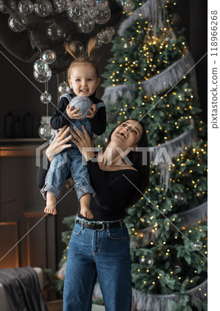 Joyful moment with mother and child by Christmas tree 118966268