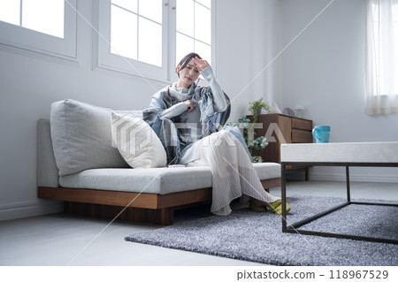 Wide angle of woman feeling unwell and sick with cold and fever at home 118967529