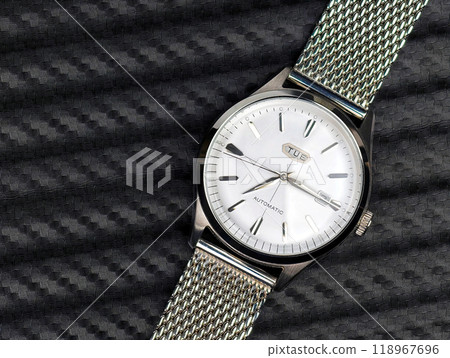A luxurious automatic dress watch with a clean white dial, ready to be worn to a party A luxurious automatic dress watch with a clean white dial, ready to be worn to a party 118967696