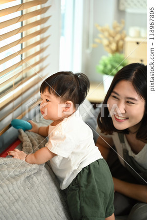 Cute asian toddler boy playing with toys on sofa with mother. Childhood and nurturing care concept Cute asian toddler boy playing with toys on sofa with mother. Childhood and nurturing care concept 118967806