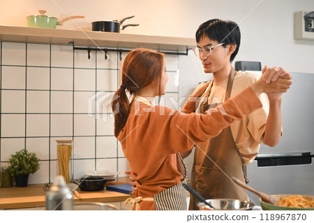Happy young couple enjoying a tender moment dancing together in their cozy kitchen Happy young couple enjoying a tender moment dancing together in their cozy kitchen 118967870