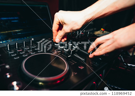 hands of DJ controllers for music on professional mixer for mixing music hands of DJ controllers for music on professional mixer for mixing music 118969452