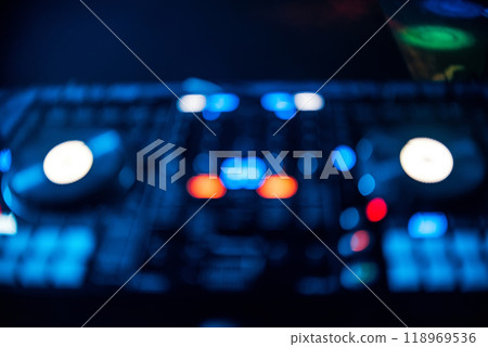 blurred out focus Board DJ with glowing buttons in nightclub blurred out focus Board DJ with glowing buttons in nightclub 118969536
