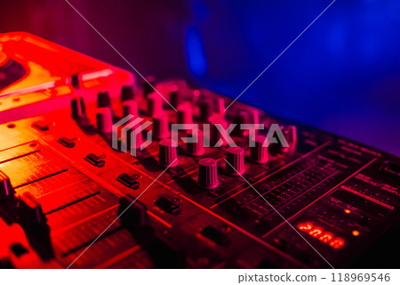 music dj panel mixer in a booth at a nightclub music dj panel mixer in a booth at a nightclub 118969546