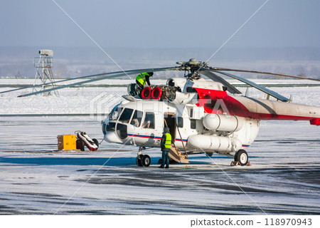 Helicopter engine repair on the winter airport apron Helicopter engine repair on the winter airport apron 118970943