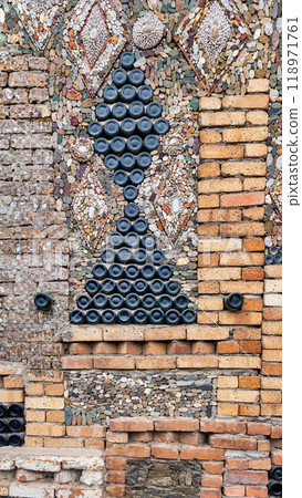 Glass bottle decoration on the Bottle House in Ganja, Azerbaijan - a triangular shapes made from stacked bottles 118971761
