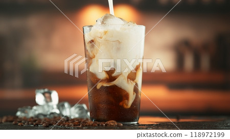 Pouring Milk into Coffee Drink in Detail. 118972199