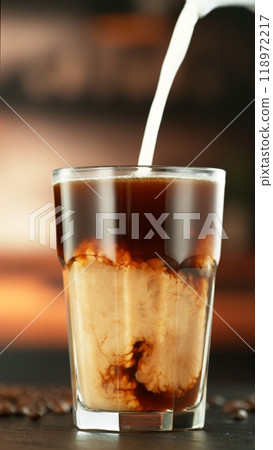Pouring Milk into Coffee Drink in Detail. Pouring Milk into Coffee Drink in Detail. 118972217