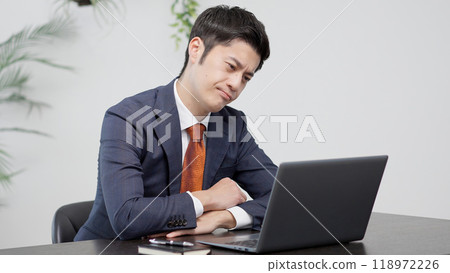 A businessman worried in front of a computer 118972226