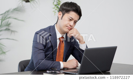 A businessman worried in front of a computer 118972227