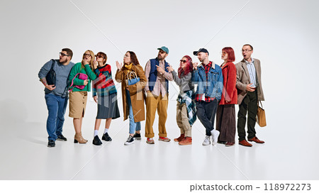 Group of people, men and women wearing stylish autumn outfits, waiting for seasonal sales. Ready to grab the best discounts Group of people, men and women wearing stylish autumn outfits, waiting for seasonal sales. Ready to grab the best discounts 118972273