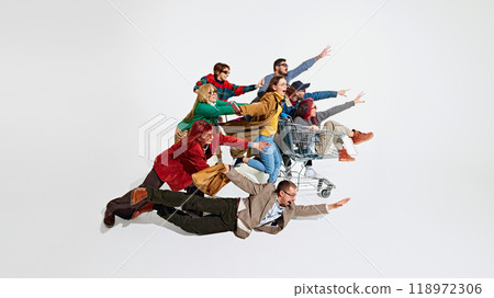 Group of emotional people, in stylish clothes running with excitement for Black Friday sales, trying to get the best discounts. 118972306