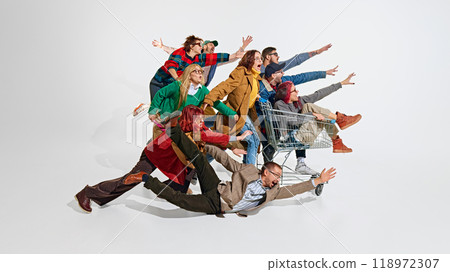 Group of emotional people, men in women pushing forward the best shopping deals, pushing shopping cart. Intensity of shopping activity Group of emotional people, men in women pushing forward the best shopping deals, pushing shopping cart. Intensity of shopping activity 118972307