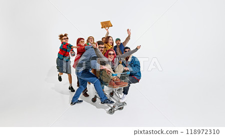Group of emotional people, men in women pushing forward the best shopping deals, pushing shopping cart. Intensity of shopping activity 118972310