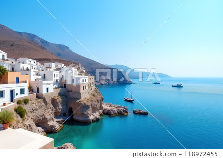Seaside view of white buildings along rocky cliffs under bright blue skies in a coastal village 118972455
