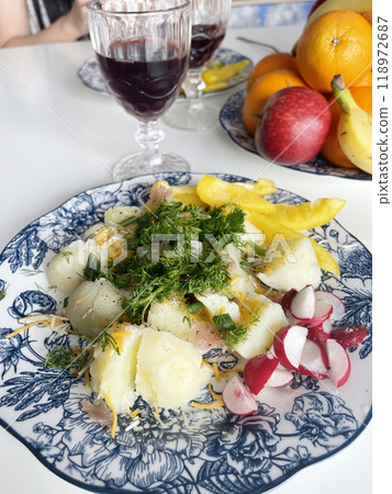 European cuisine, potatoes with dill salad and radishes. glass of wine 118972687