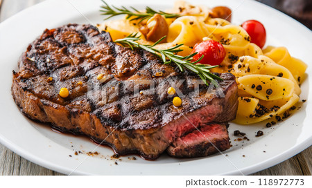 Steaks. Delicious steak served with pasta and potatoes 118972773