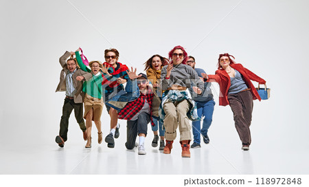 Group of stylish young people expressing excitement and urgency about best Black Friday deals, running forward to get best proposal. 118972848