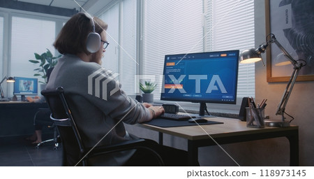 Adult man in headphones types prompt in AI video generator on PC Adult man in headphones types prompt in AI video generator on PC 118973145