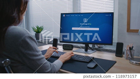 Adult woman types prompt in AI chatbot on PC. Generated portrait of sci-fi robot Adult woman types prompt in AI chatbot on PC. Generated portrait of sci-fi robot 118973157