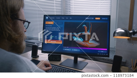 Adult man types prompt in AI video generator software on PC 118973184