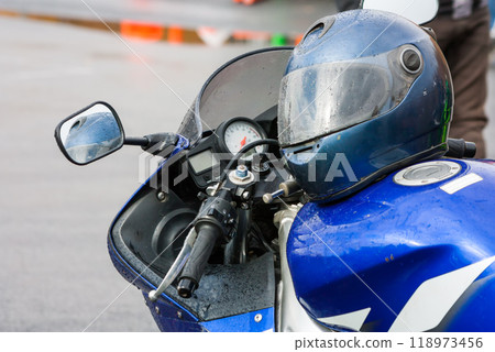 Helmet on a motorcycle in the rain Helmet on a motorcycle in the rain 118973456