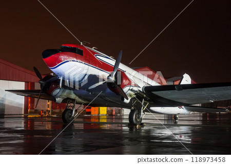 Retro airplane on the rainy night at the airport 118973458