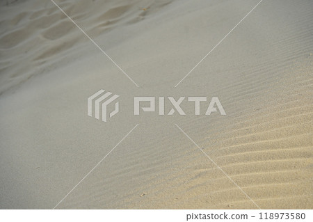 Summer in Tottori Prefecture, Tottori Sand Dunes: Wind ripples and footprints in the sand bathed in the pale light of early morning Summer in Tottori Prefecture, Tottori Sand Dunes: Wind ripples and footprints in the sand bathed in the pale light of early morning 118973580