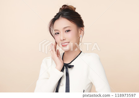 Beautiful young asian woman with clean fresh skin on beige background, Face care, Facial treatment, Cosmetology, beauty and spa, Asian women portrait. Beautiful young asian woman with clean fresh skin on beige background, Face care, Facial treatment, Cosmetology, beauty and spa, Asian women portrait. 118973597