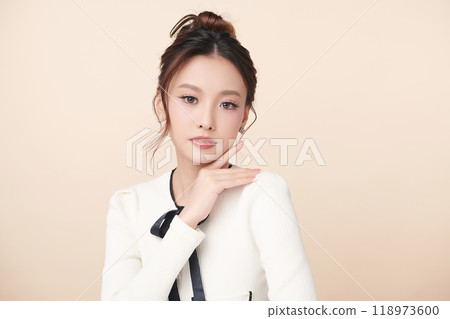 Beautiful young asian woman with clean fresh skin on beige background, Face care, Facial treatment, Cosmetology, beauty and spa, Asian women portrait. Beautiful young asian woman with clean fresh skin on beige background, Face care, Facial treatment, Cosmetology, beauty and spa, Asian women portrait. 118973600