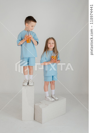 Two young children have fun in the studio on an white background. 118974441