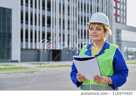 Confident mature female engineer developer inspector at construction site Confident mature female engineer developer inspector at construction site 118974485