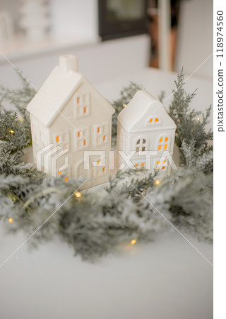 Miniature houses and fir trees on white background. Cozy small world. Christmas decorations, holiday concept. Miniature houses and fir trees on white background. Cozy small world. Christmas decorations, holiday concept. 118974560