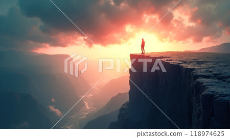 Lone explorer on mountain cliff during golden hour, vast wilderness view, serene sunset over rugged peaks, inspirational solo journey backdrop, dramatic outdoor adventure setting in wilderness 118974625