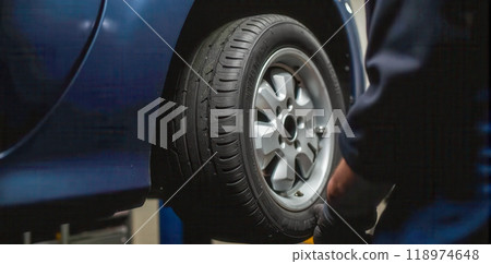 Car tire close-up with mechanic working in garage, vehicle maintenance, wheel repair, auto service professional, workshop scene, automotive industry detail Car tire close-up with mechanic working in garage, vehicle maintenance, wheel repair, auto service professional, workshop scene, automotive industry detail 118974648