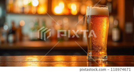 Cold beer glass on bar counter, amber liquid with frothy head, blurred bottles background, warm light, refreshing alcoholic beverage in pub setting Cold beer glass on bar counter, amber liquid with frothy head, blurred bottles background, warm light, refreshing alcoholic beverage in pub setting 118974671